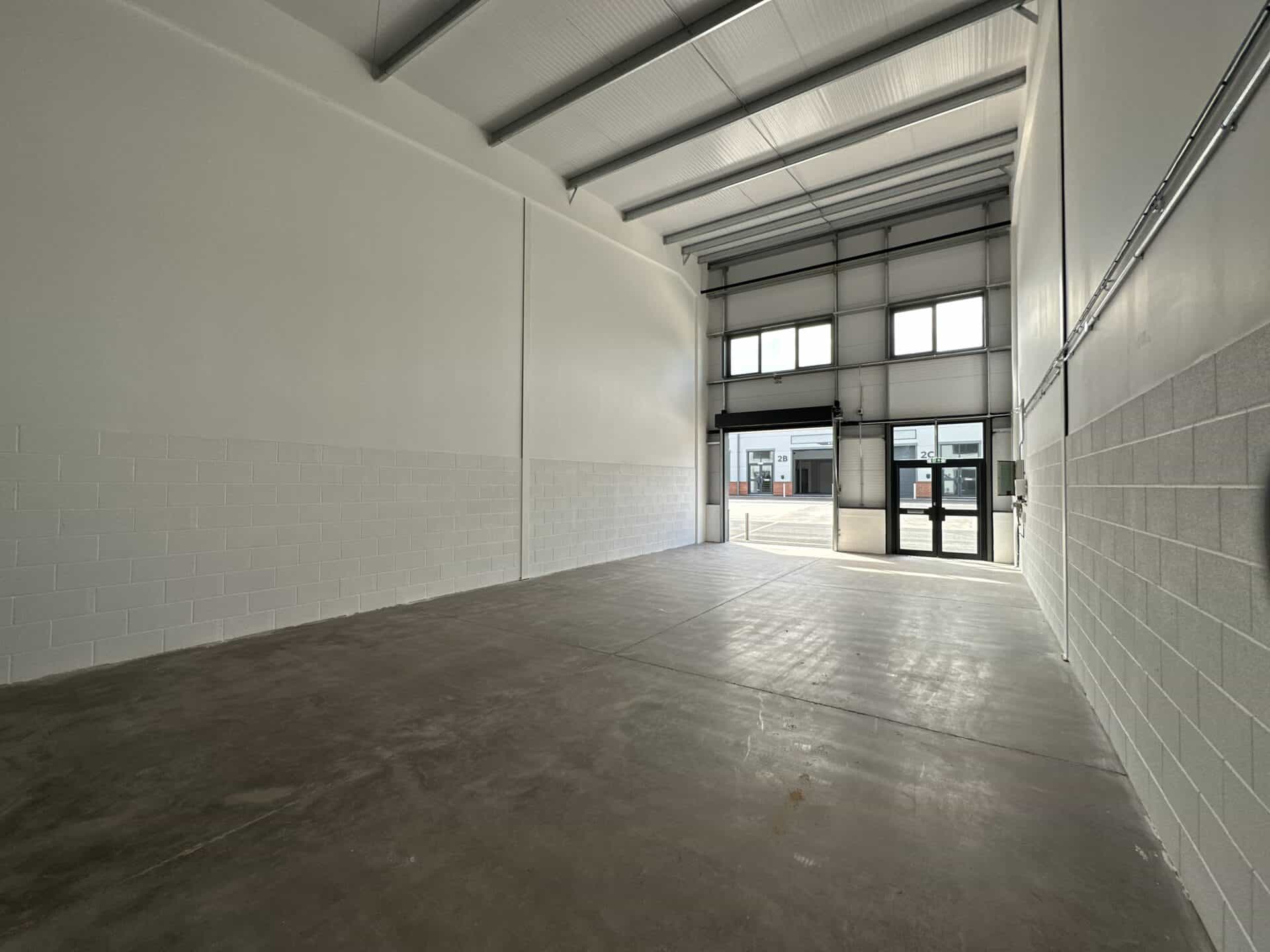 Interior view of a light industrial unit at Oak Tree, Kingskerswell, with a blank shell layout, offering flexibility for client-specific adaptations.