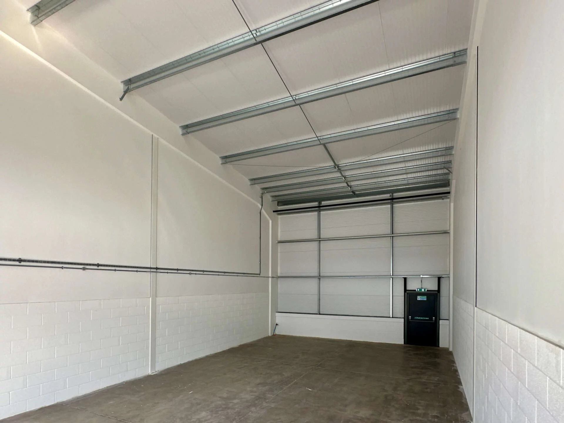Interior view of a light industrial unit at Oak Tree, Kingskerswell, with a blank shell layout, offering flexibility for client-specific adaptations.