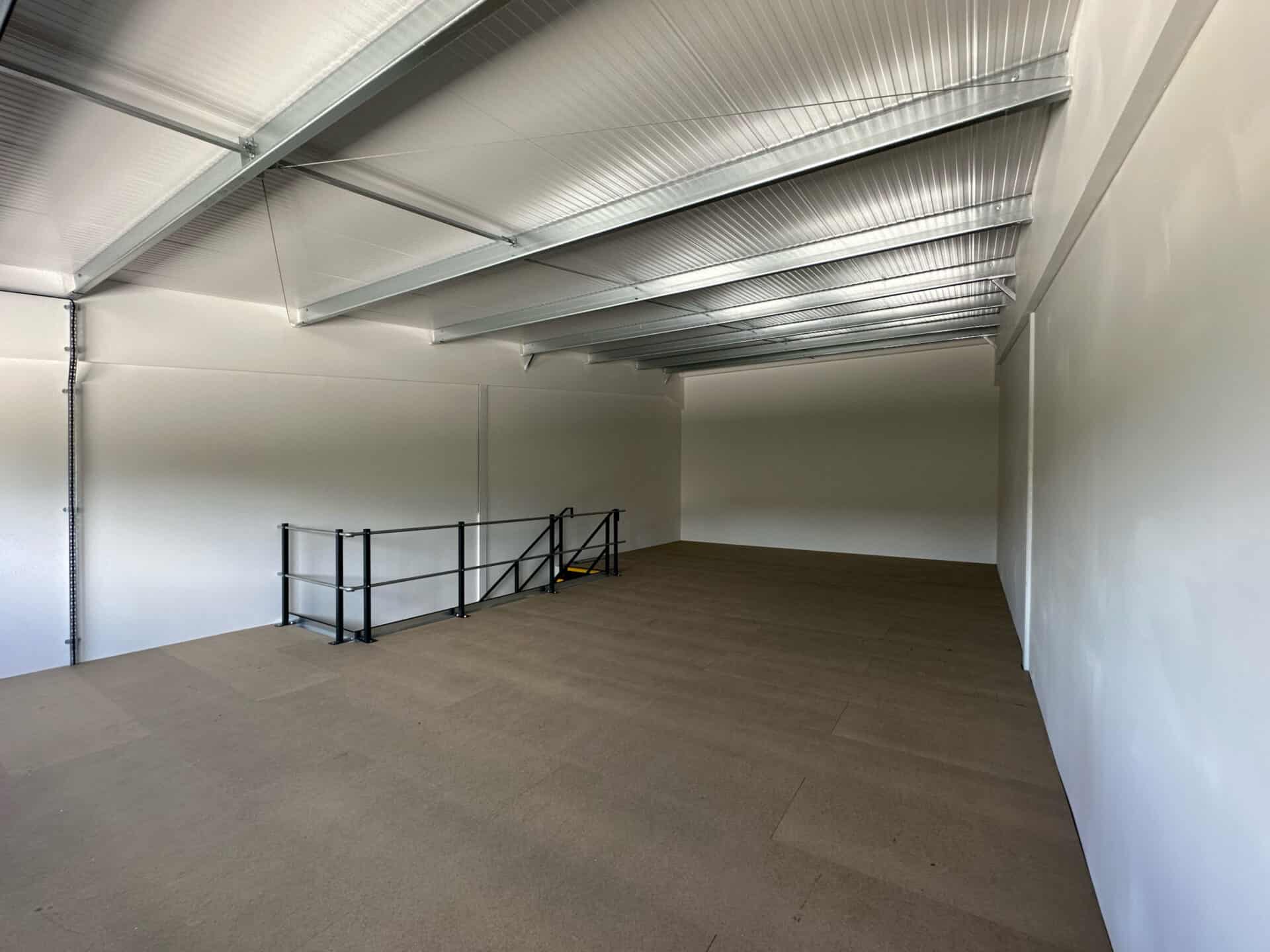 Interior view of a light industrial unit at Oak Tree, Kingskerswell, with a full mezzanine layout, offering flexibility for client-specific adaptations.