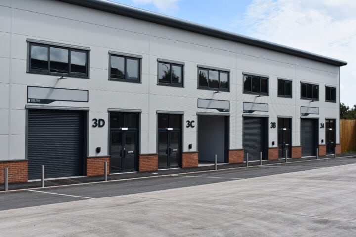 Exterior view of a row of units at Oak Tree, Kingskerswell, showcasing the commercial spaces in this location.