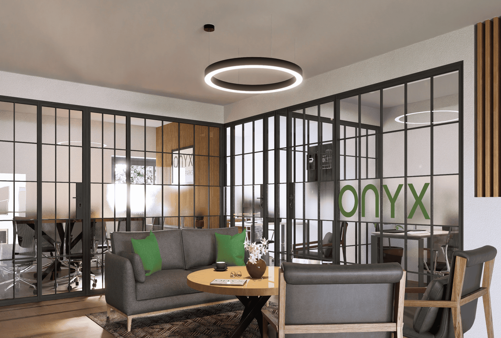 A modern office space with a glass-walled conference room and a cozy seating area. The room features a grey sofa with green pillows, two armchairs, and a round wooden table. The design includes industrial-style elements and circular ceiling lights.