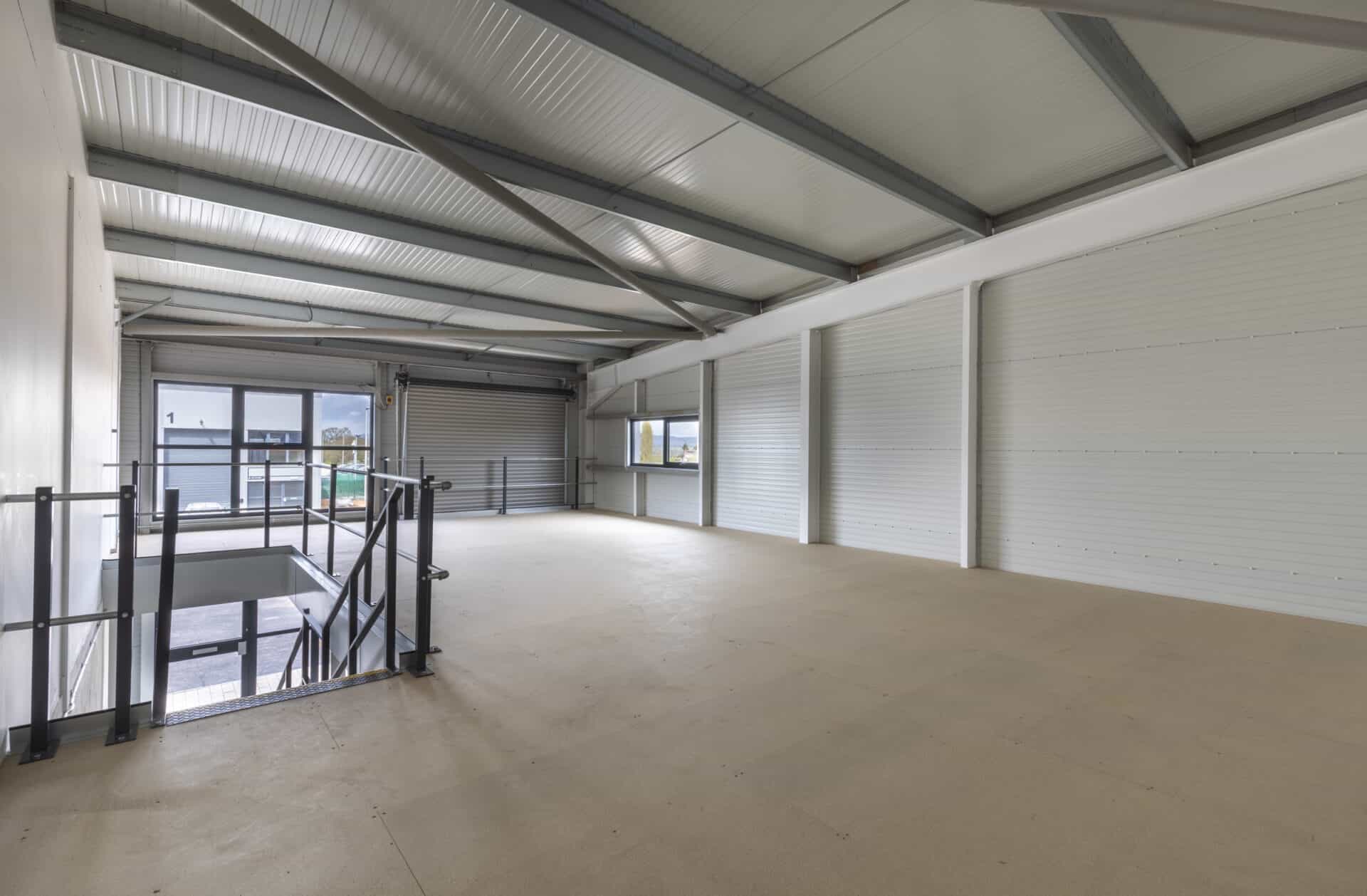 Interior view of a light industrial unit with a full mezzanine layout, offering flexibility for client-specific adaptations.