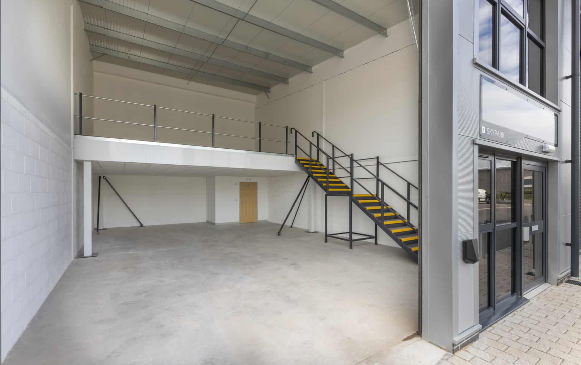 Interior view of a light industrial unit with a half mezzanine layout, offering flexibility for client-specific adaptations.