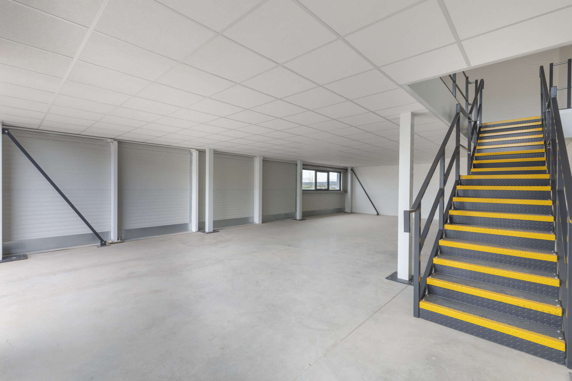 Interior view of a fully constructed light industrial unit featuring a spacious mezzanine layout. This blank canvas awaits customisation to cater to a client's specific requirements.