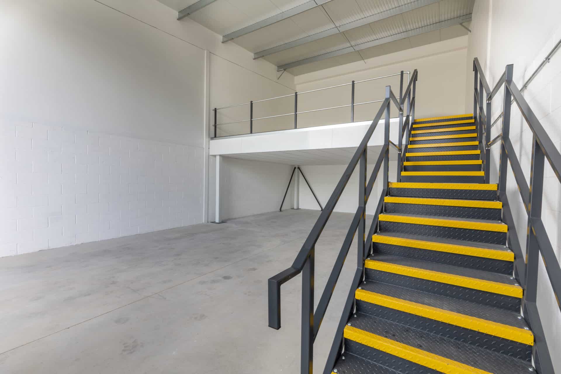 Interior view of a light industrial unit with a half mezzanine layout, offering flexibility for client-specific adaptations.