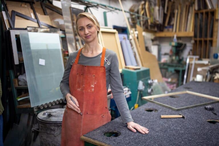 Portrait of an proud and confident female glazier, a small business owner in their light industrial unit