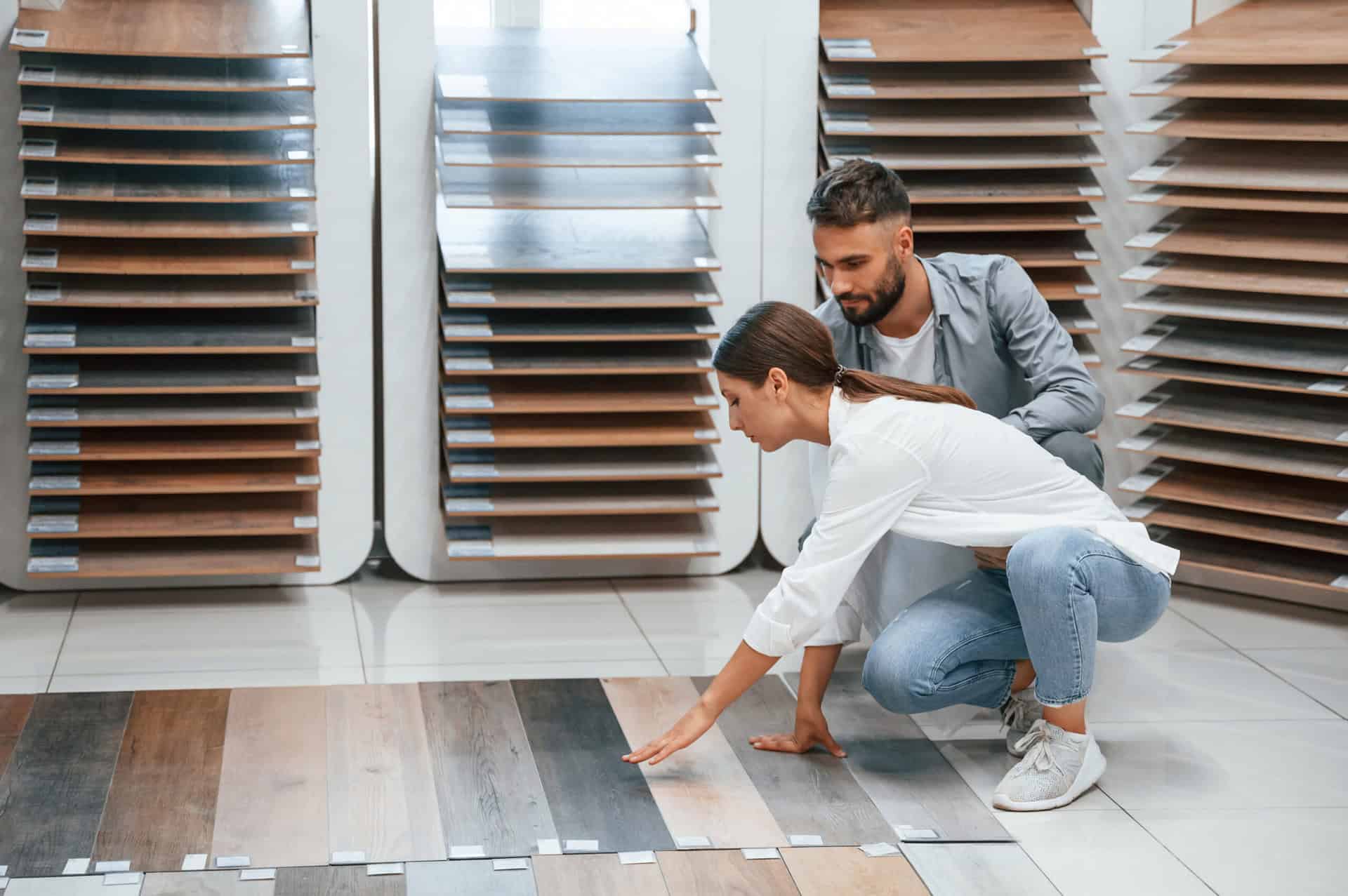 Occupiers of a light industrial unit at SkyPark, reviewing different floorboard options. This photo is an interior shot of a flooring contractors showroom.